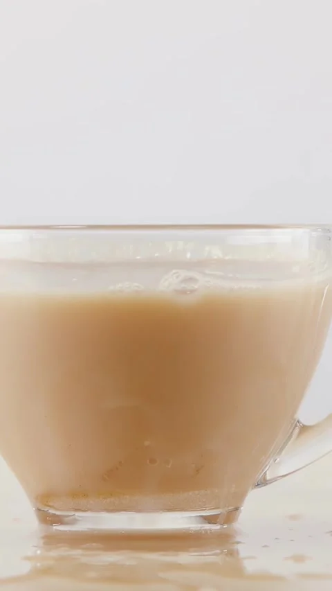 Slow Motion Coffee and Milk Splash in Glass Cup Stock Footage 341925109