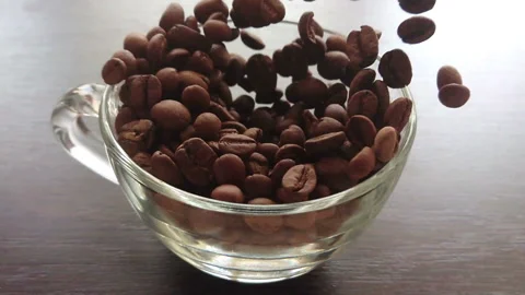 Slow motion of coffee beans falling into a glass Stock Footage 88672763