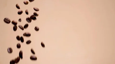 Slow motion coffee beans falling left of frame Stock Footage 94772537