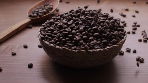 Slow motion of coffee beans falling into a rustic bowl Stock Footage 130519163