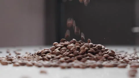 Slow Motion Coffee Beans Falling onto Pile of Roasted Beans Vídeo Stock 330538861