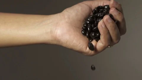 Slow motion, Coffee beans pouring, falling from held by woman hand. Stock Footage 79026410