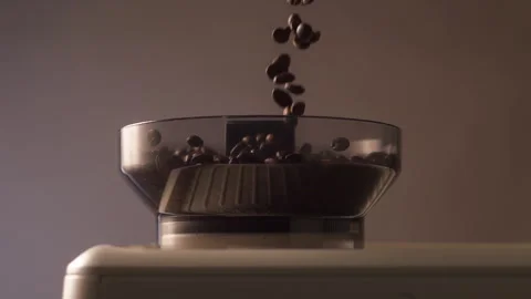 Slow Motion Coffee Beans Pouring into Grinder for Luxury Ad Vidéo 329095118