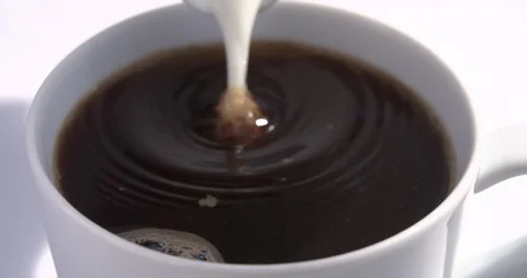 Slow motion coffee clouds swirling in coffee mug Stock Footage 91450672