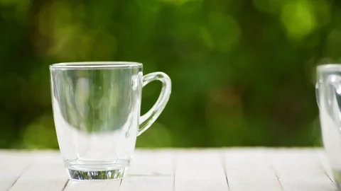 Slow motion of coffee cup in a garden Stock Footage 100451303