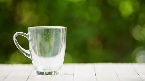Slow motion of coffee cup in a garden Stock-Footage 100451305