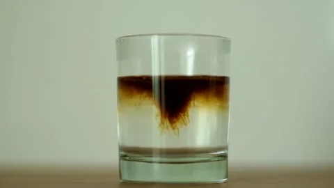 Slow motion coffee dissolve Stock Footage 153251892