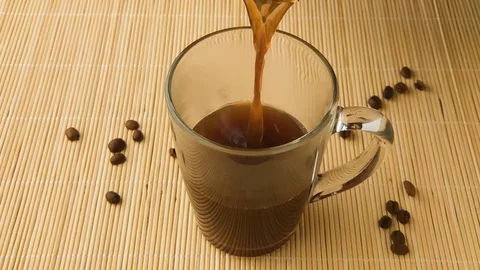 Slow Motion coffee finished pour. Coffee cup and coffee beans. Stock Footage 130020810