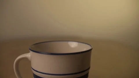 Slow motion coffee pouting into coffee cup Stock Footage 76250518