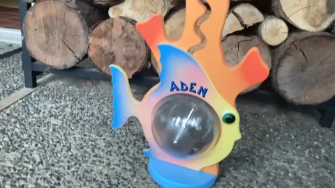 Slow-motion coins falling into fish piggy bank Stock Footage 149898341