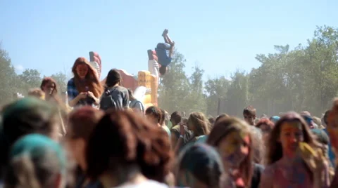 Slow motion color fest Holi guy jumping on a trampoline Stock Footage 51553497