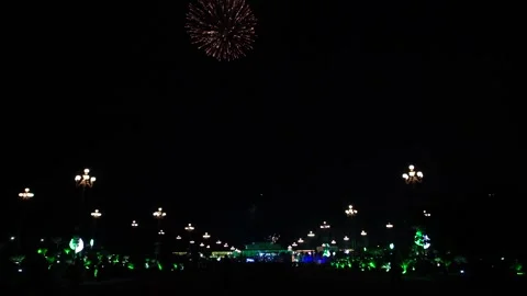 Slow Motion Colorful fireworks that explode and fill the darkness of the nig Stock Footage 204620514