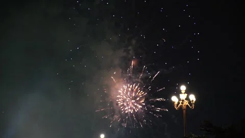 Slow Motion Colorful fireworks that explode and fill the darkness of the nig Stock Footage 204636007