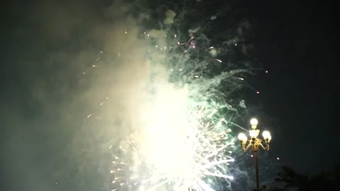 Slow Motion Colorful fireworks that explode and fill the darkness of the nig Stock Footage 204636402