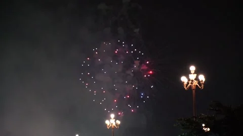 Slow Motion Colorful fireworks that explode and fill the darkness of the nig Stock Footage 204637990