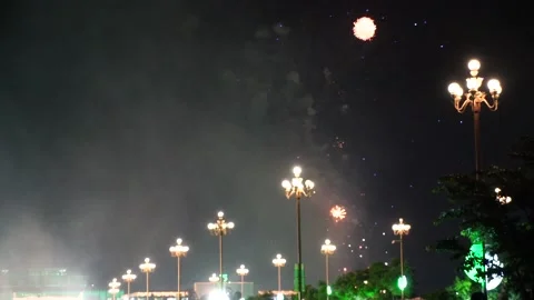 Slow Motion Colorful fireworks that explode and fill the darkness of the nig Stock Footage 204708246