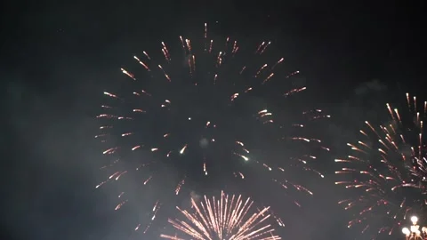 Slow Motion Colorful fireworks that explode and fill the darkness of the nig Stock Footage 204708251