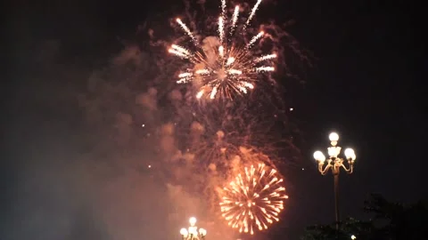 Slow Motion Colorful fireworks that explode and fill the darkness of the nig Stock Footage 204708331