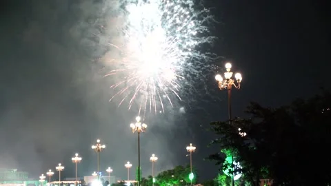 Slow Motion Colorful fireworks that explode and fill the darkness of the nig Stock Footage 204708373