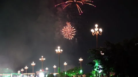 Slow Motion Colorful fireworks that explode and fill the darkness of the nig Stock Footage 204708425