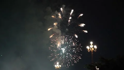 Slow Motion Colorful fireworks that explode and fill the darkness of the nig Stock Footage 204708444