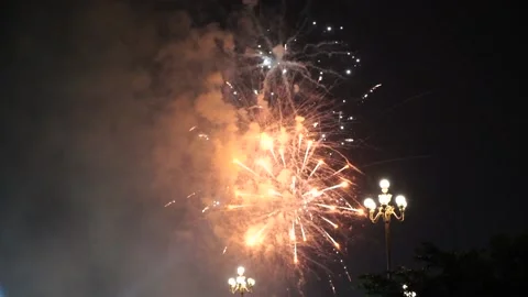 Slow Motion Colorful fireworks that explode and fill the darkness of the nig Stock Footage 204708513