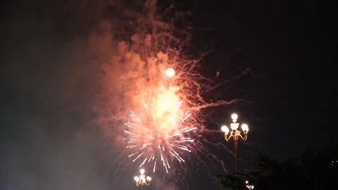 Slow Motion Colorful fireworks that explode and fill the darkness of the nig Stock Footage 204708523