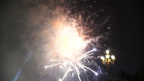 Slow Motion Colorful fireworks that explode and fill the darkness of the nig Stock Footage 204708593