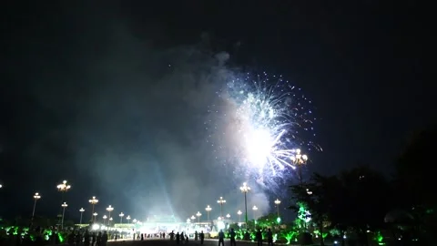 Slow Motion Colorful fireworks that explode and fill the darkness of the nig Stock Footage 204708635