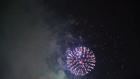 Slow Motion Colorful fireworks that explode and fill the darkness of the nig Stock Footage 204708767