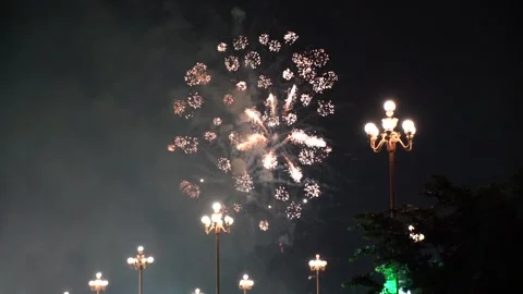 Slow Motion Colorful fireworks that explode and fill the darkness of the nig Stock Footage 204711297