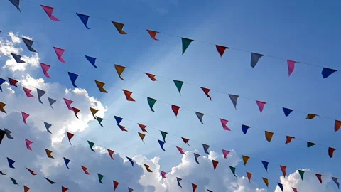Slow motion of colorful triangular fair flags blowing on the wind Stock Footage 133339923
