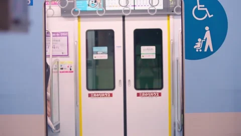 Slow motion of commuters exiting metro train as doors open onto clean platform Stock Footage 322639374