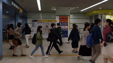 Slow motion: Commuters walking through train station during rush hour in Tokyo. Stock Footage 123814801