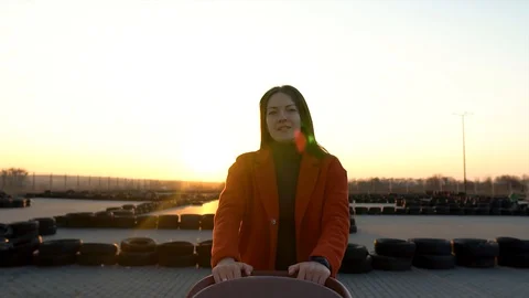 A slow motion of confident mother walking with a pram. Sunset behind, silhouette Stock Footage 128772519
