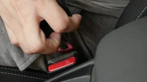 Slow motion connection of passenger 3-point seat belt on buckle Stock Footage 94176997