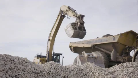 Slow Motion Construction Backhoe Empties Dirt Into Dump Truck Stock Footage 144904948
