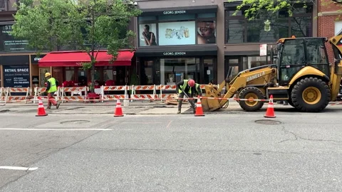 Slow motion: Construction Workers &amp; Equipment on the side of a city Street NYC Stock Footage 130881214