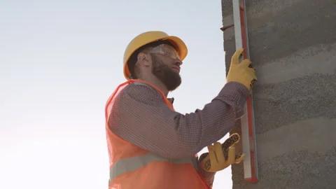 Slow motion of construction workers measuring a building under the sun Stock-Footage 303229103