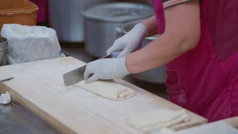 Slow motion of cook chopping dough to make fresh Korean noodles Stock Footage 313674759