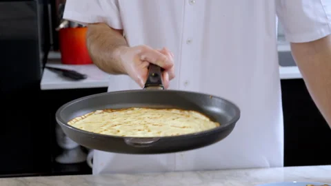 Slow motion as the cook flips the pancakes to the other side. Stock Footage 277452226