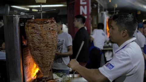 Slow Motion Cook Sharpening Knife While Al Pastor Cooks In Mexico City Stock Footage 154643395