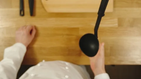 SLOW MOTION: Cook throws up scoop and catches it - Top View Vídeo Stock 99083002