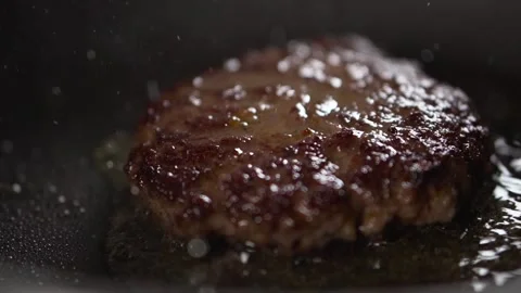 Slow motion, cooking beef and pork cutlets for burger. Stock Footage 248160775