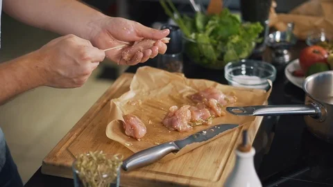 Slow motion of cooking meat by chef, in kitchen puts pieces of fillet on skewers Stock Footage 123353316