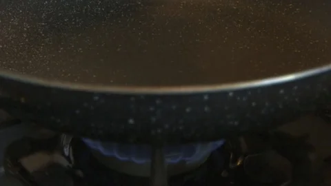 Slow motion of cooking oil falling on a hot pan Stock Footage 122183532