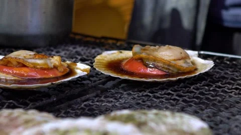 Slow motion cooking in outer market street of Tsukiji, burning fresh scallop-Dan Video stock 147468699
