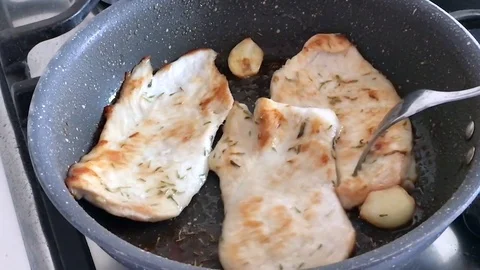 Slow motion of cooking slice of chicken with olive oil in a pot. Stock-Footage 79853763