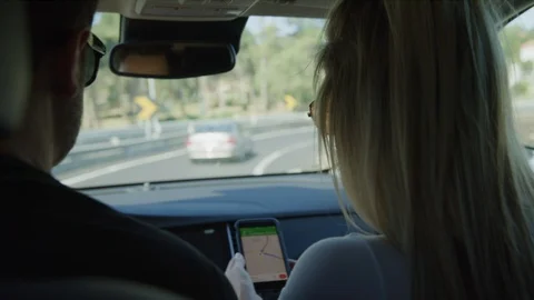 Slow motion of couple in car navigating with map on cell phone / Sintra, Lisboa, Stock Footage 100783037