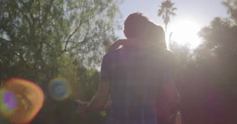 Slow motion couple dance in Los Angeles park with lens flares 4K Stock Footage 68223202